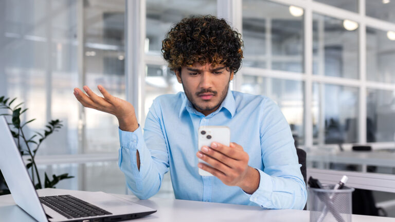 Young man in a co-working space with bad mobile connectivity